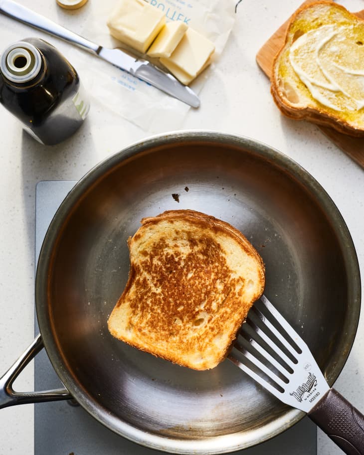 grilled cheese being cooked in butter and olive oil