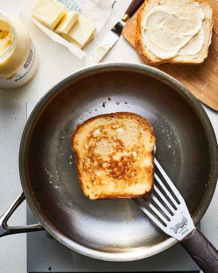 grilled cheese being cooked in butter and mayo