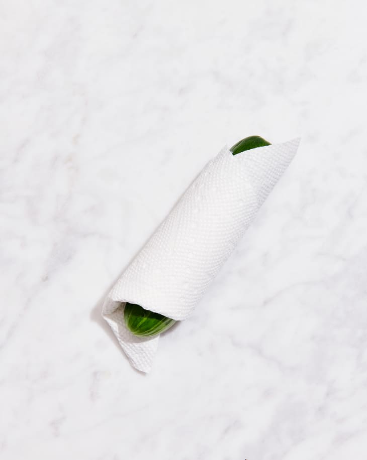 persian cucumber in paper towel on marble counter
