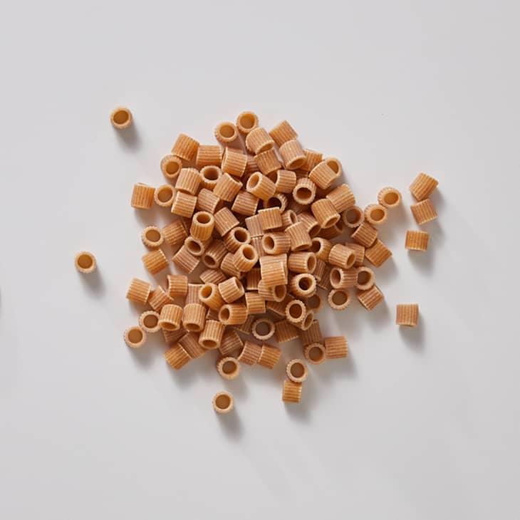 Ditalini on a white surface.