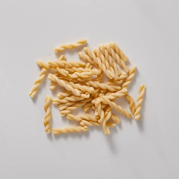 gemelli pasta on a white surface