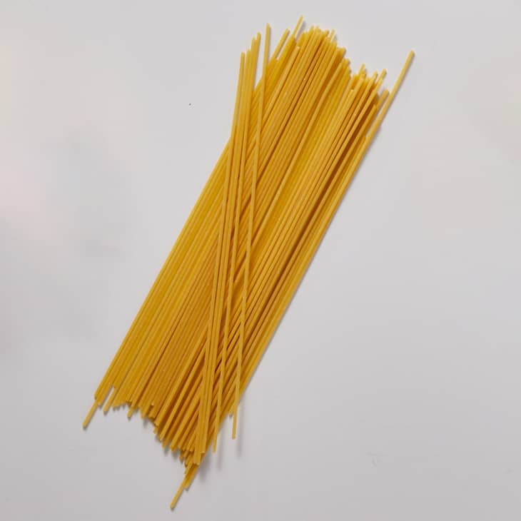 Spaghetti on a white surface.