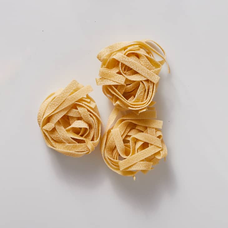 Tagliatelle on a white surface.