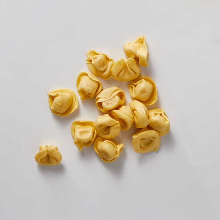Tortellini on a white surface.