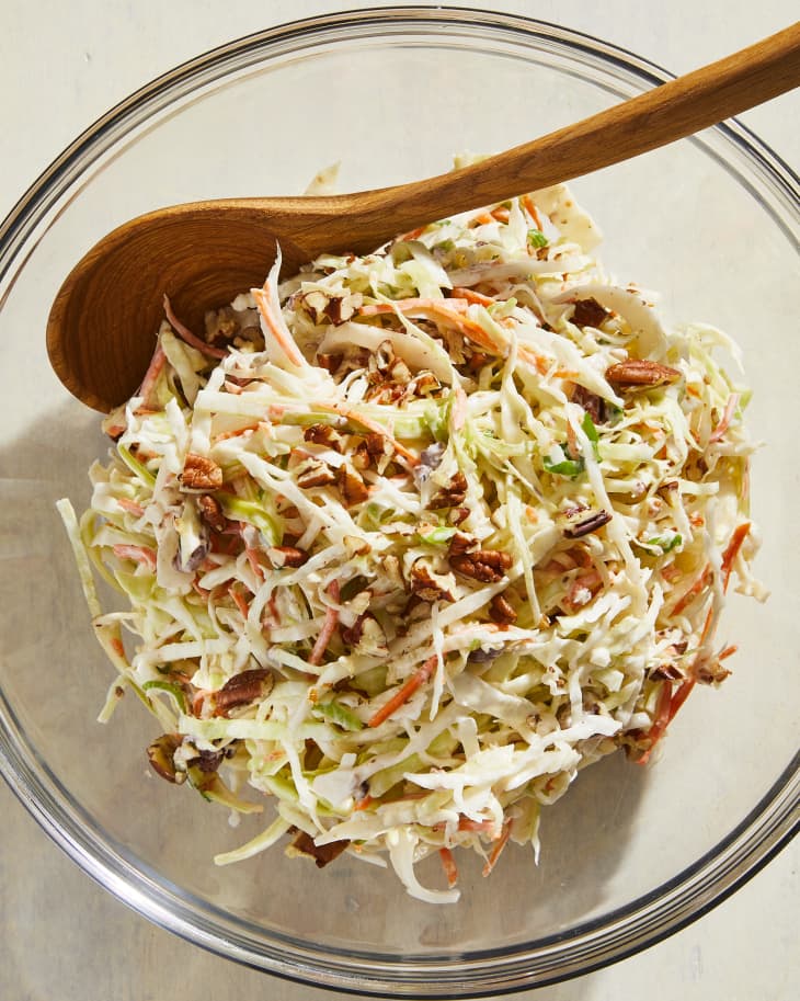 Nigella Lawson's coleslaw in serving bowl with wooden spoon.