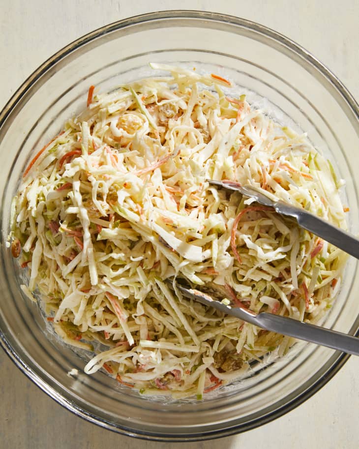 Sunny Anderson's coleslaw in serving bowl with tongs.