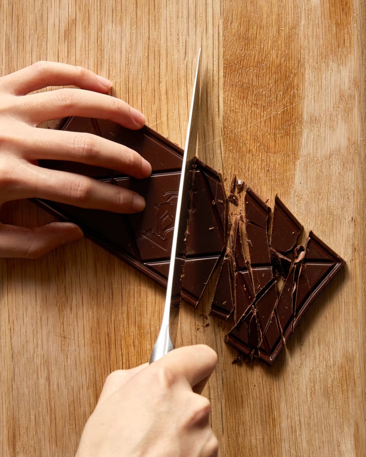 someone chopping chocolate