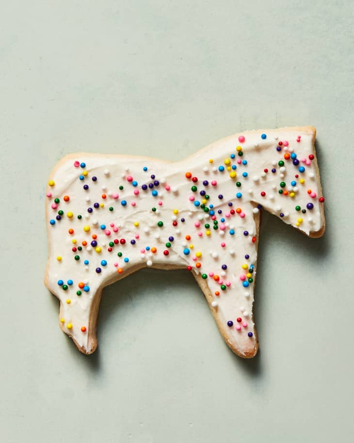 family sugar cookie in horse shape on green