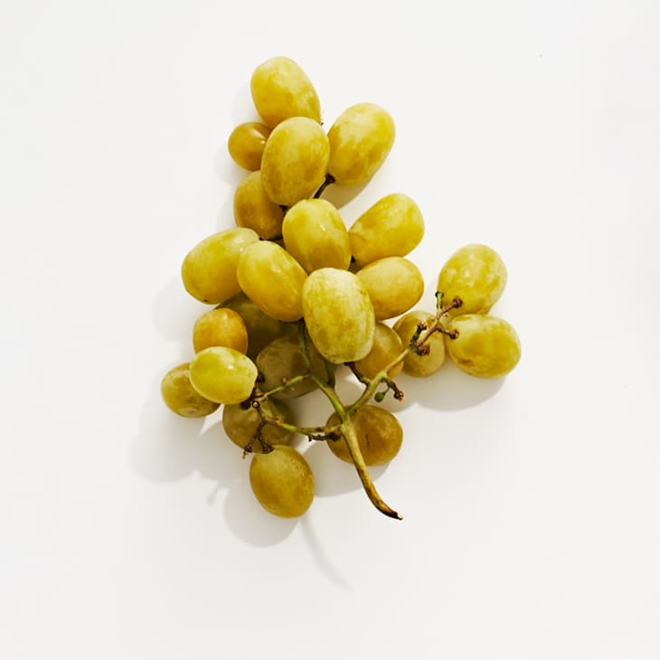 Cotton candy grapes on a white surface.