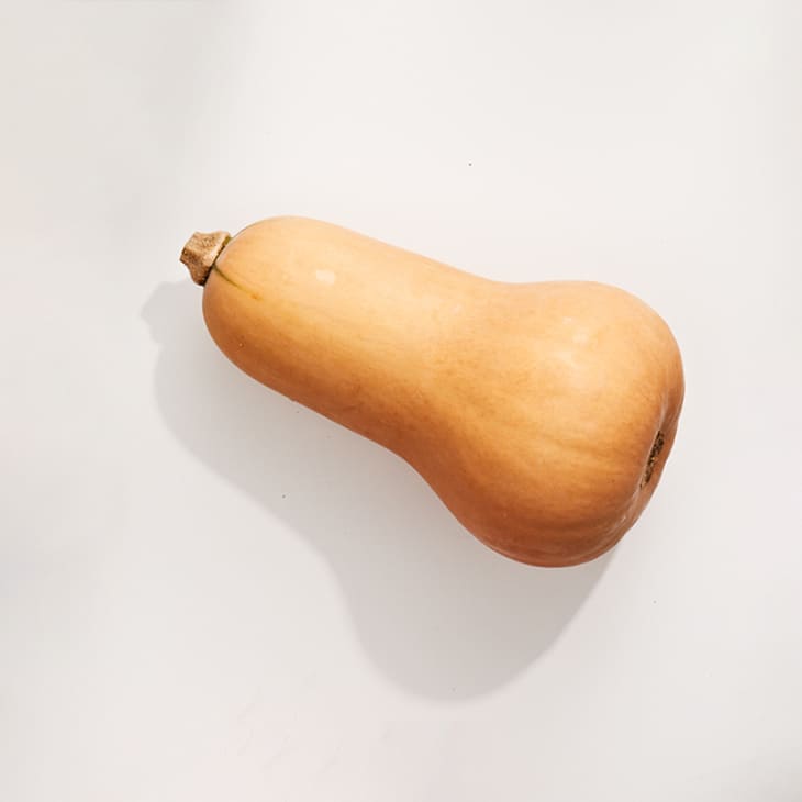 Butternut squash on a white surface.