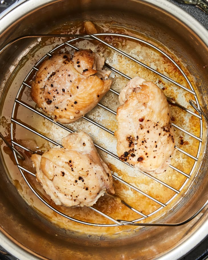 Overhead photo of boneless skinless chicken thighs cooking in Instant Pot