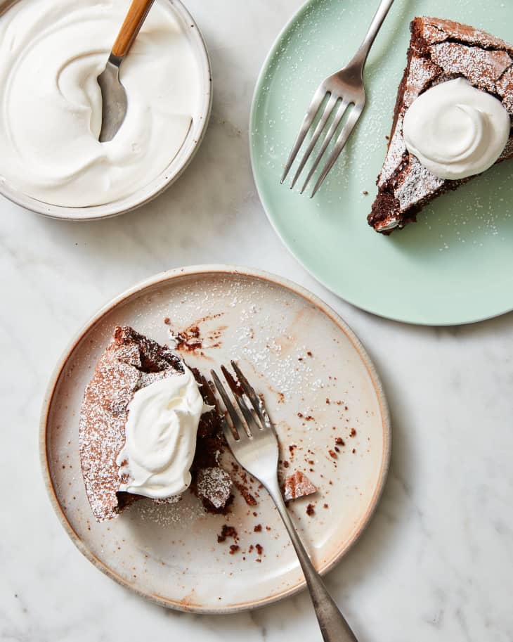 flourless chocolate cake on plate with whipped cream