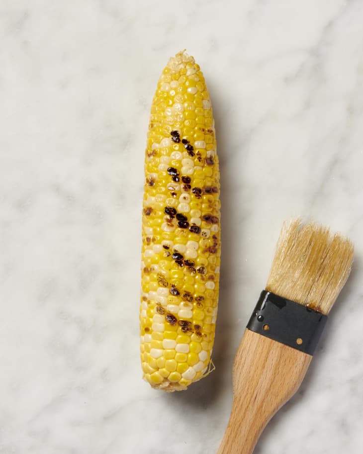 brush and grilled corn on marble