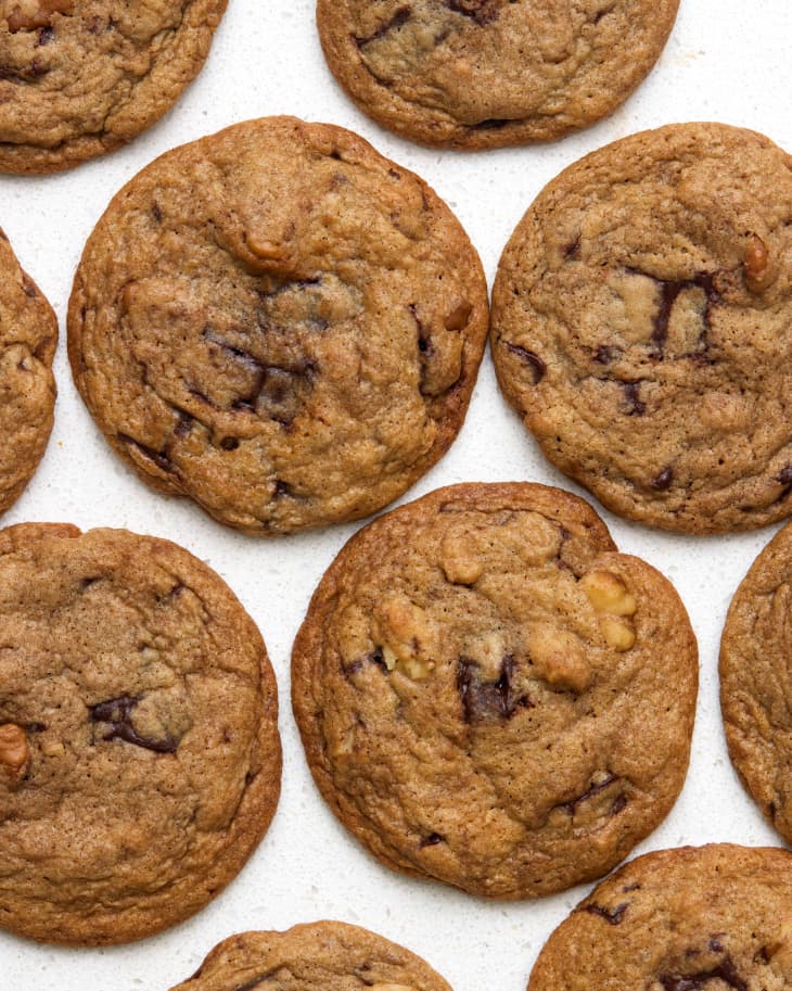 Overhead view of chocolate chip cookies on a white stone surface.