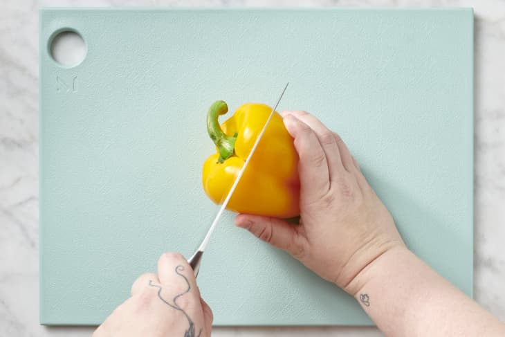 Depiction of the instructions in How to Cut a Bell Pepper for Stuffing: step 1