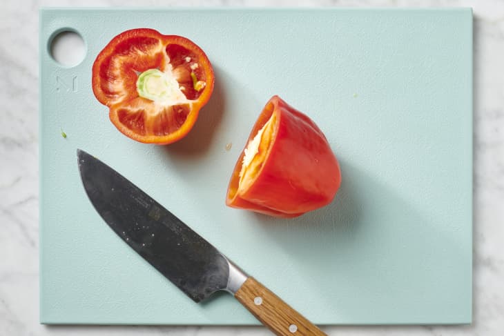 Depiction of the instructions in How to Cut a Bell Pepper Into Strips: step 1