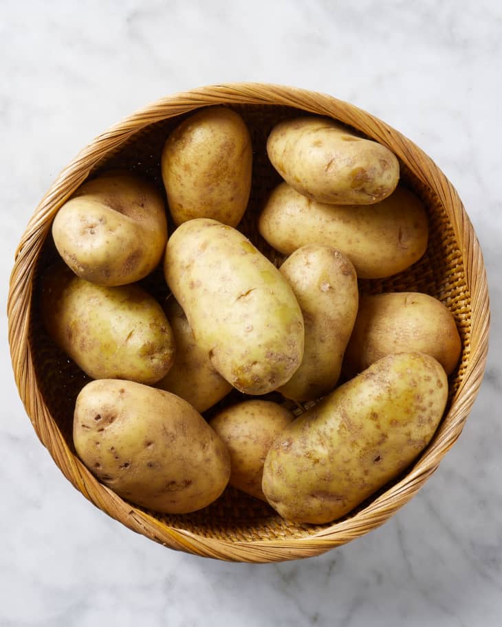 Overhead view of potatoes in a wicker basket.