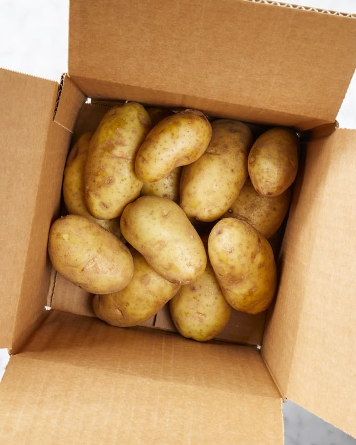 Overhead view of potatoes in a cardboard box.