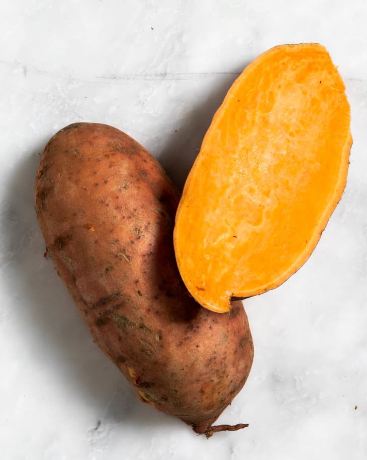 Overhead view of a cut open orange sweet potato.