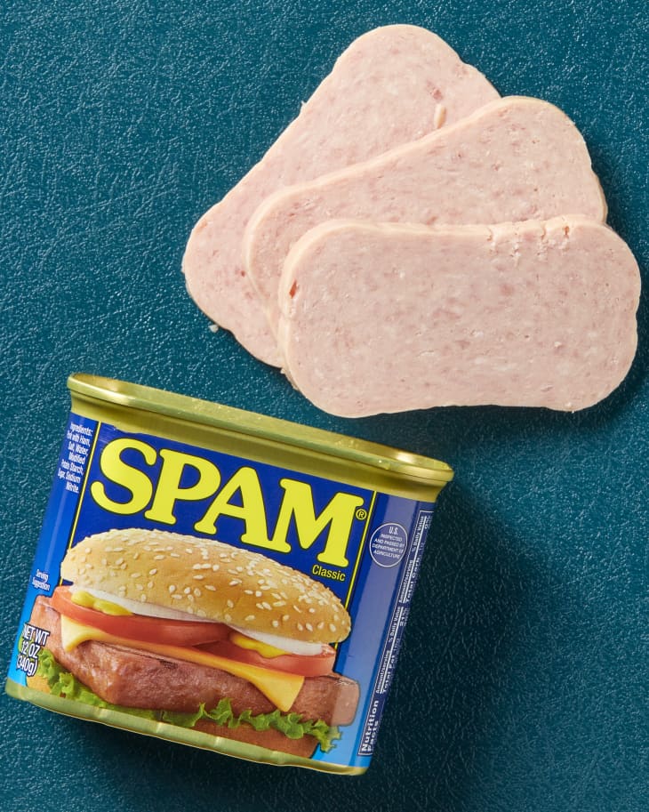 Overhead view of an open spam can with three slices coming out.