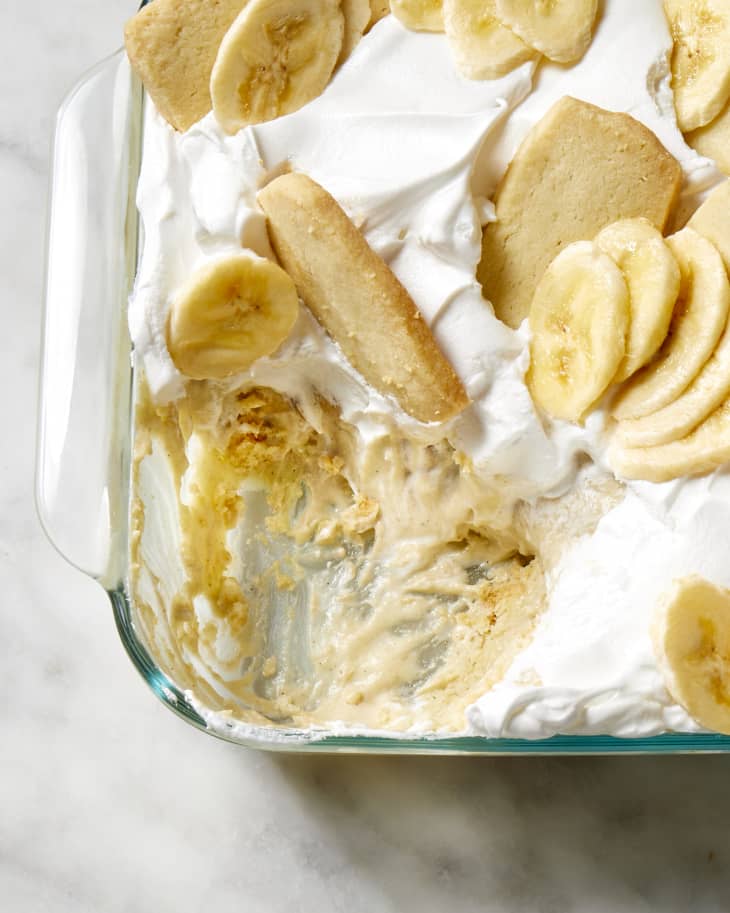 A close up view of Carla Hall's recipe for banana pudding with a scoop taken out