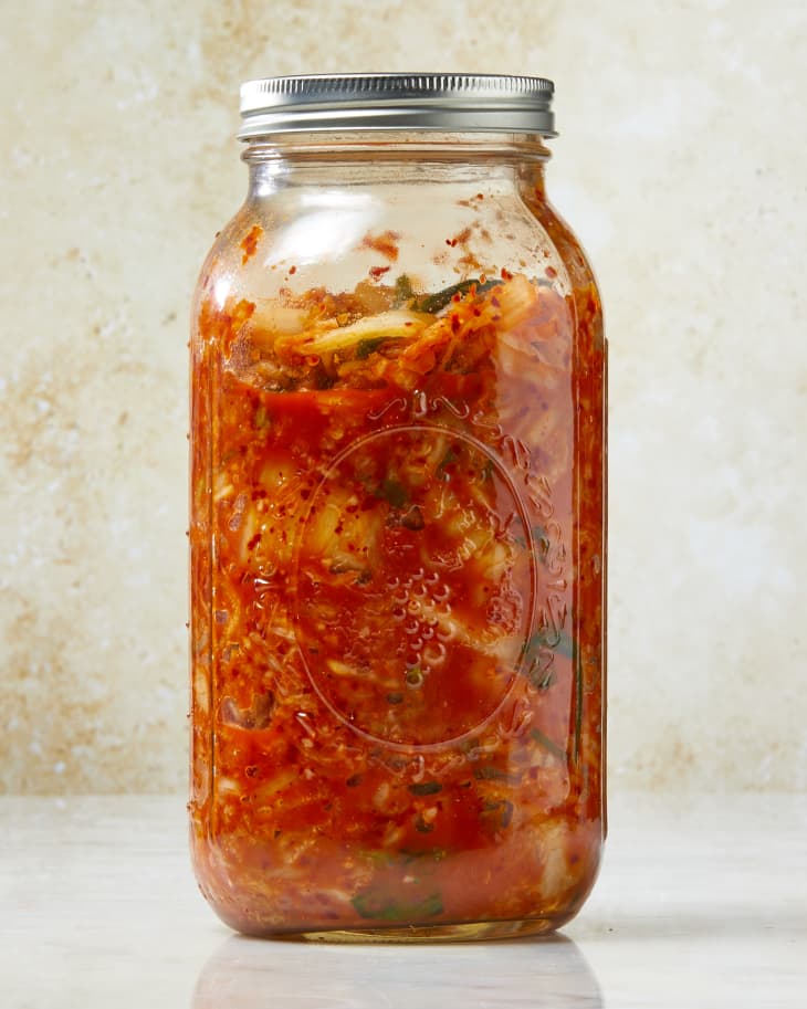 Head on shot of kimchi in a glass mason jar.