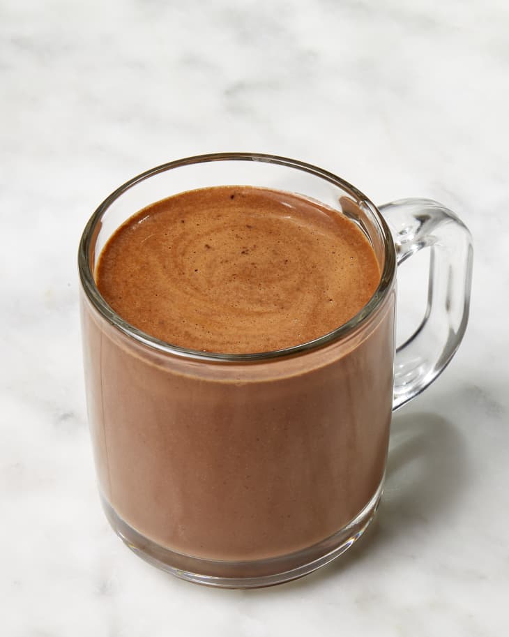 Angled shot of giada de laurentiis' hot chocolate recipe in a clear glass mug.