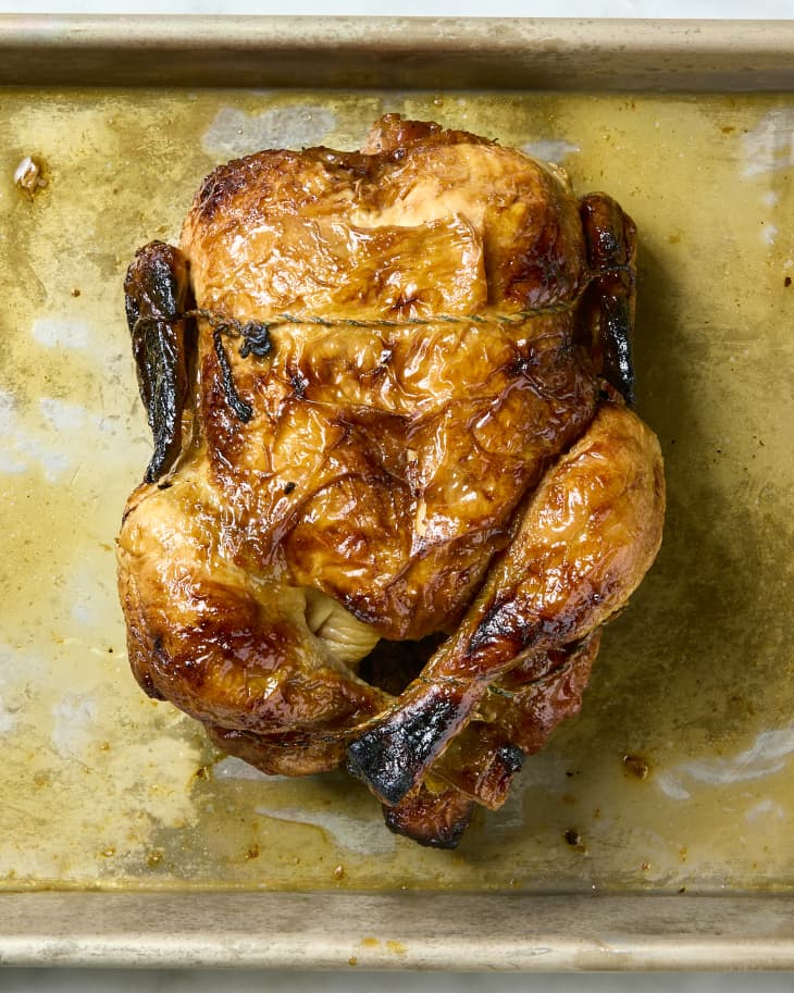 overhead shot of a rotisserie chicken on a baking sheet.