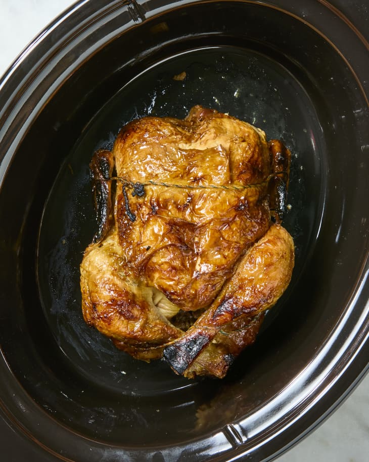 overhead shot of a rotisserie chicken in a slow cooker.