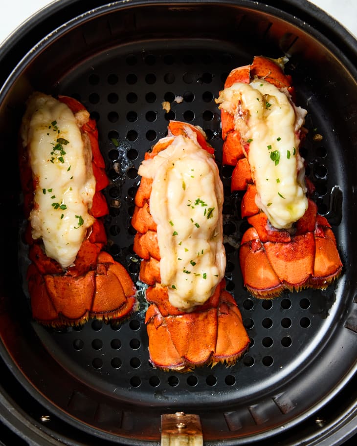 overhead shot three lobster tails in an airfryer.