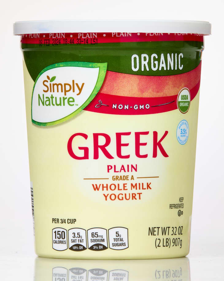 A container of Aldi Simply Nature Greek Yogurt on a white background