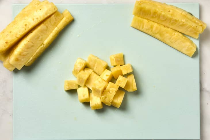 overhead shot of pineapple cut into cubes as well as spears