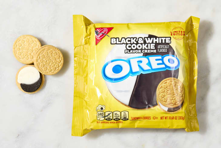 overhead shot of the black and white flavored oreos with a few cookies laying down next to the box