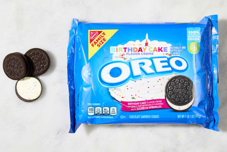 overhead shot of the birthday cake flavored oreos with a few cookies laying down next to the box