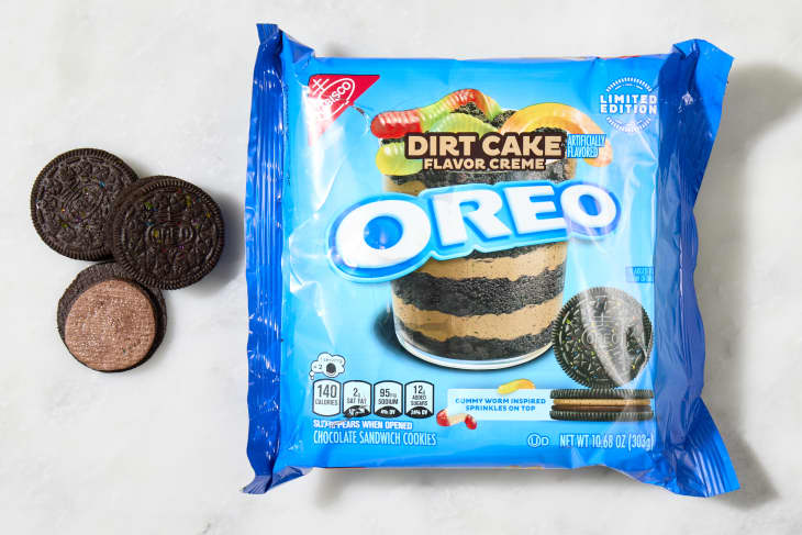 overhead shot of the dirt cake flavored oreos with a few cookies laying down next to the box