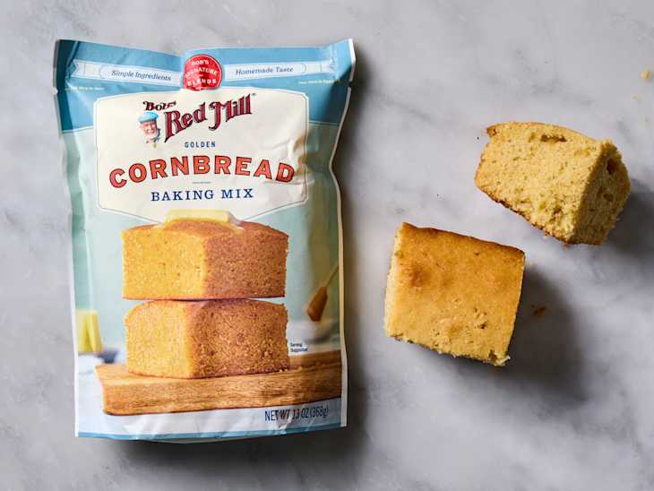 overhead shot of Bob's Red Mill Corn Bread baking mix, with two pieces of corn bread laying next to the bag