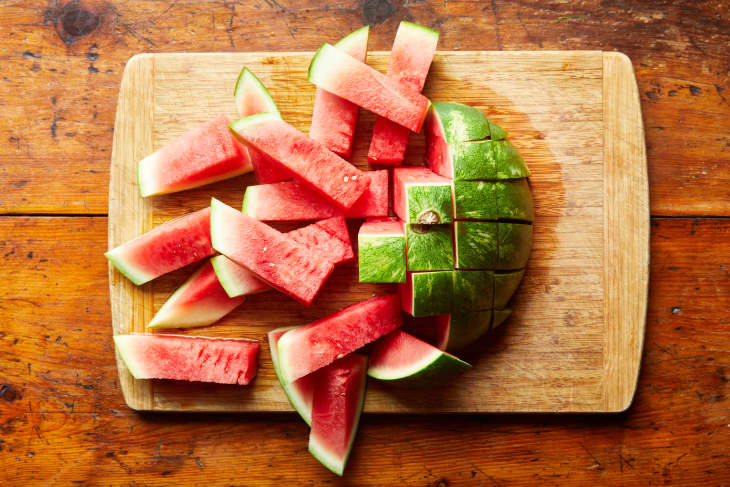 The watermelon slices lay on a cutting board.