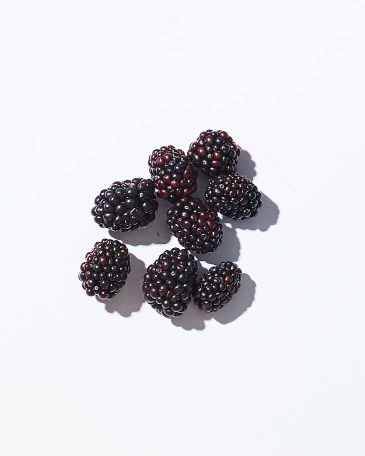 Blackberries on a white surface