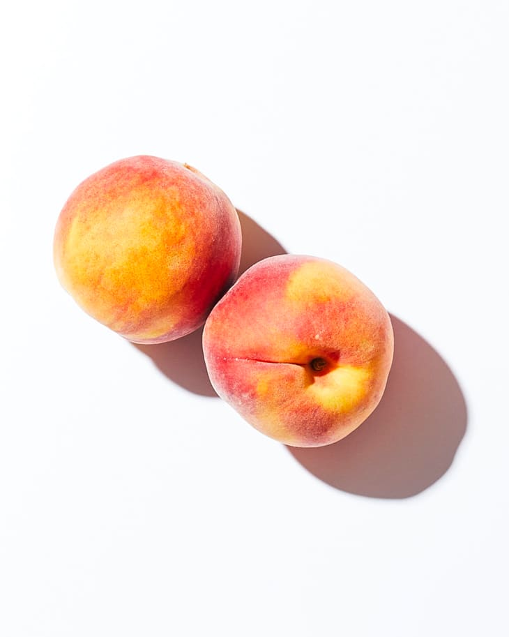 Peaches on a white surface