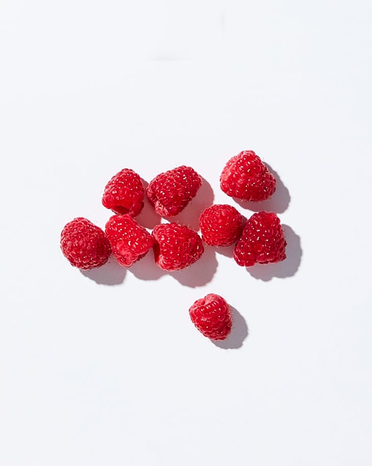 Raspberries on a white surface