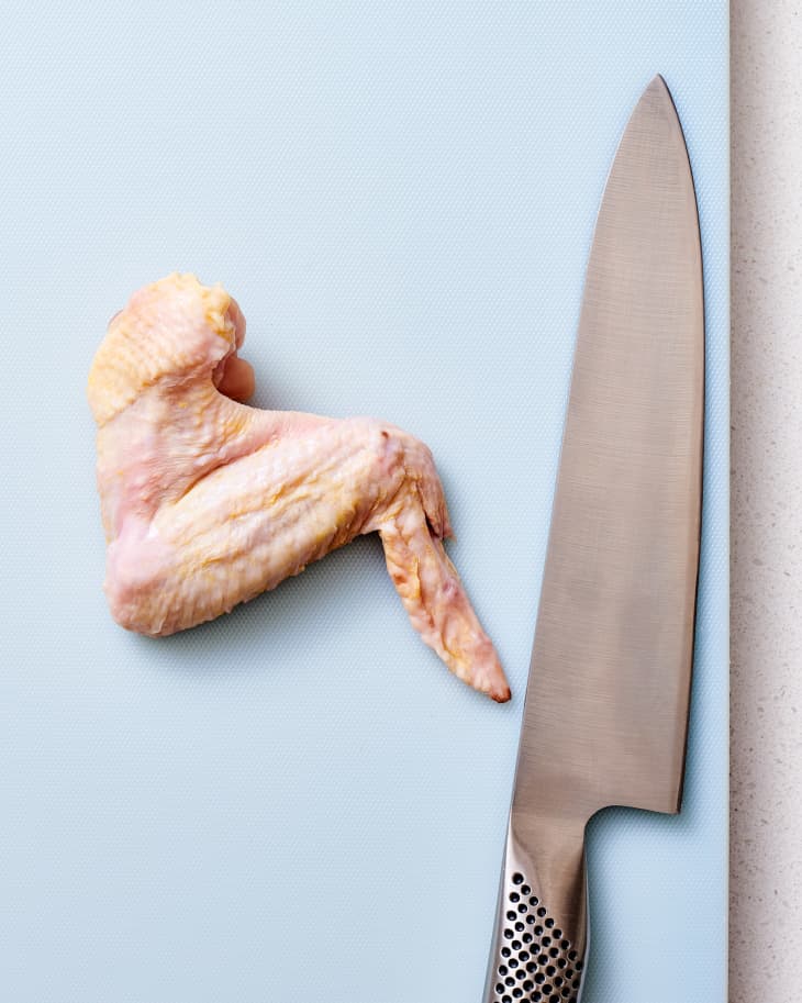 chicken wing on cutting board.