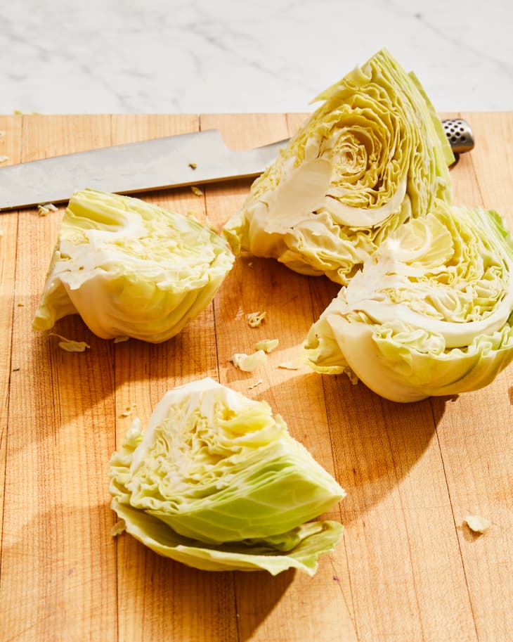 Cabbage wedges on surface.