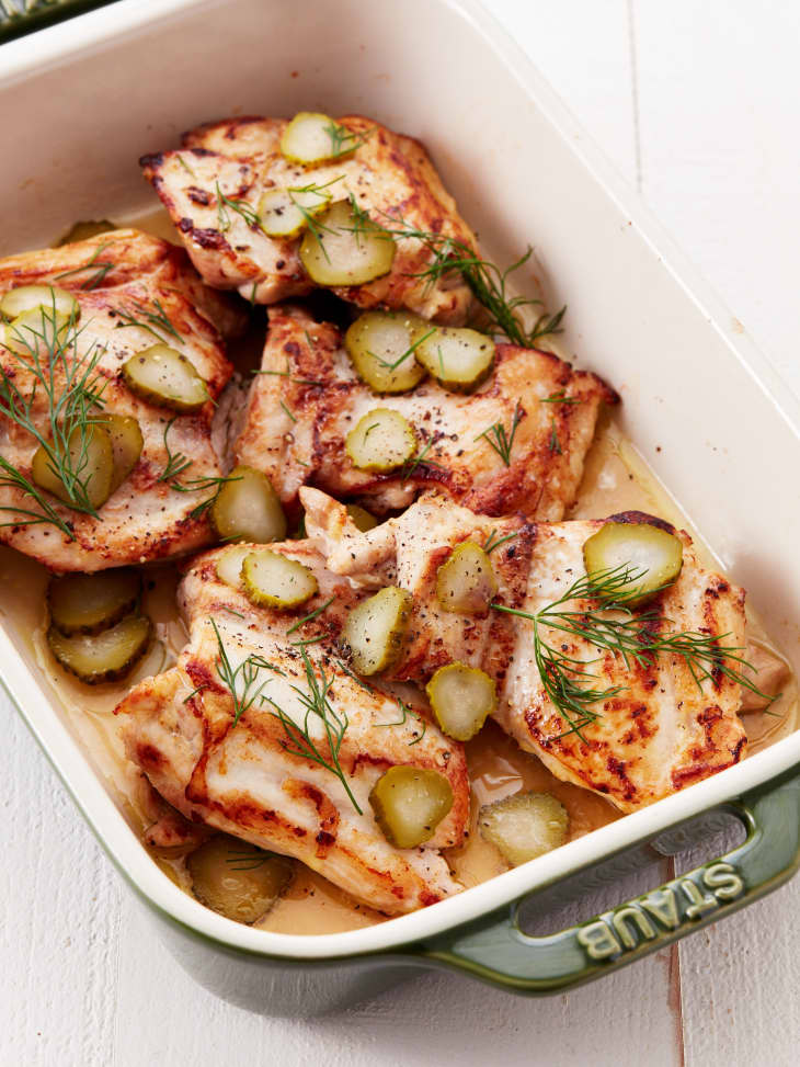 Roasted chicken with dill and pickles in a baking dish