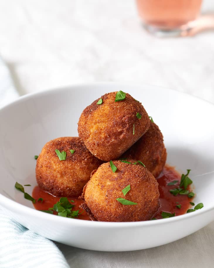Leftover risotto balls baked to perfection in a white bowl