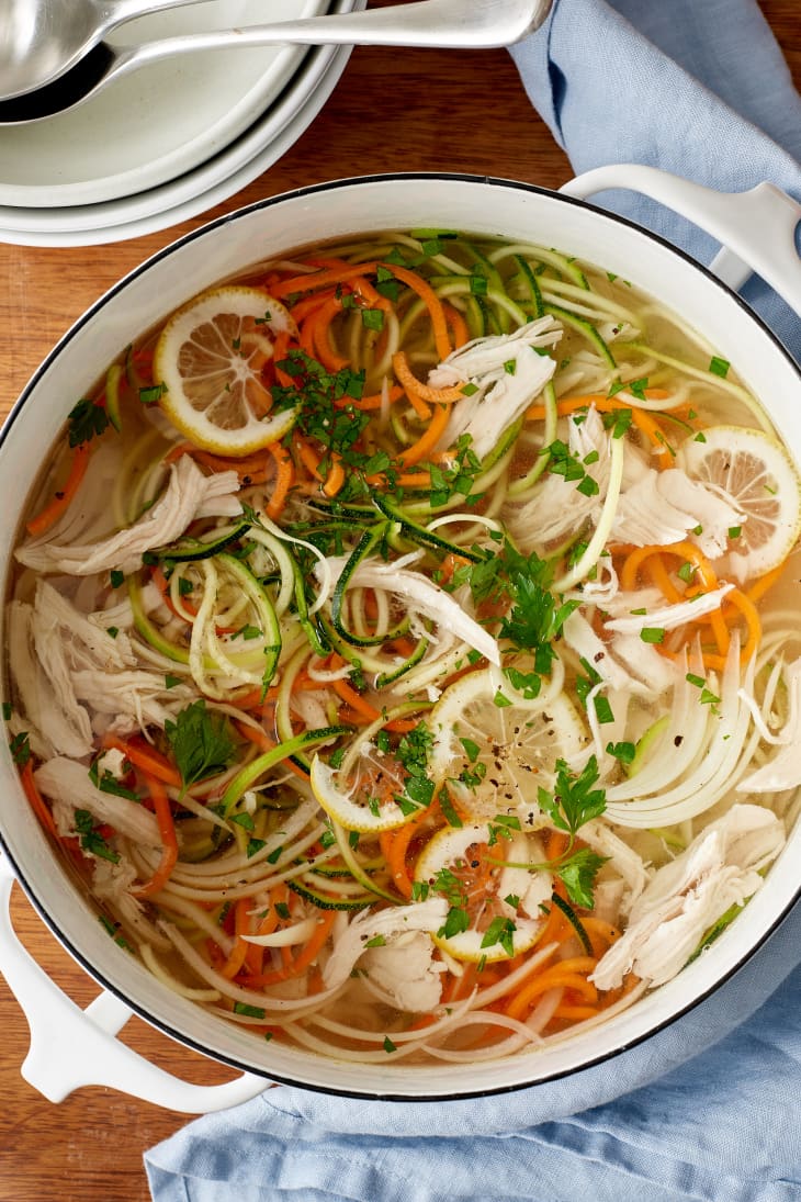 A enamelware pot of chicken zoodle soup