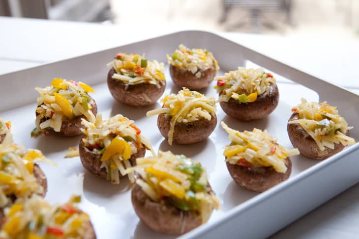 Mushrooms stuffed with cheese &amp; panko on a white tray