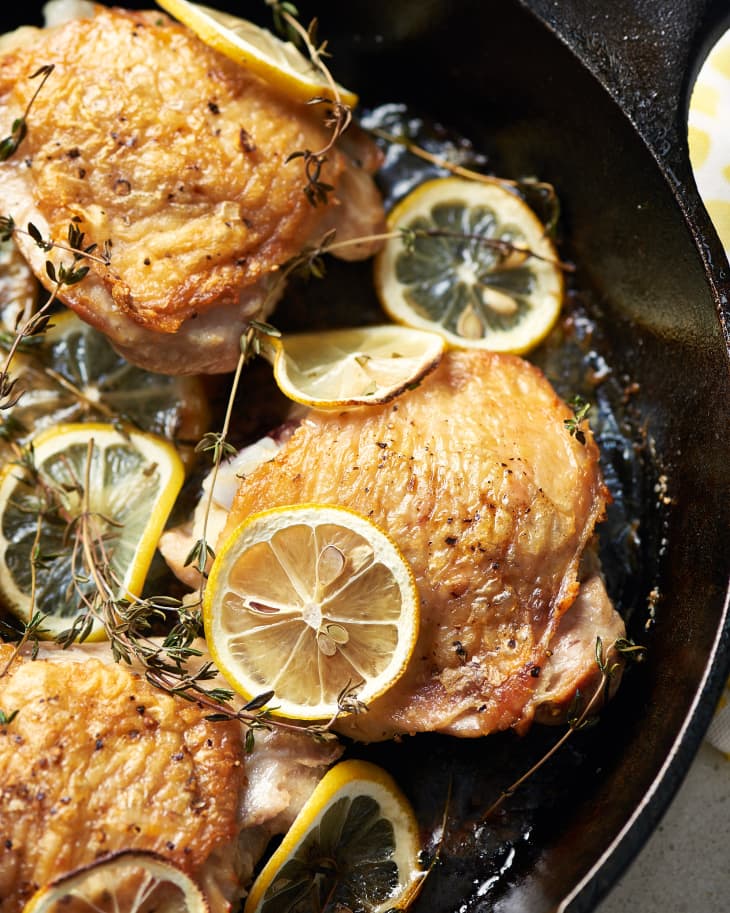 Lemon thyme chicken thighs in a cast iron skillet