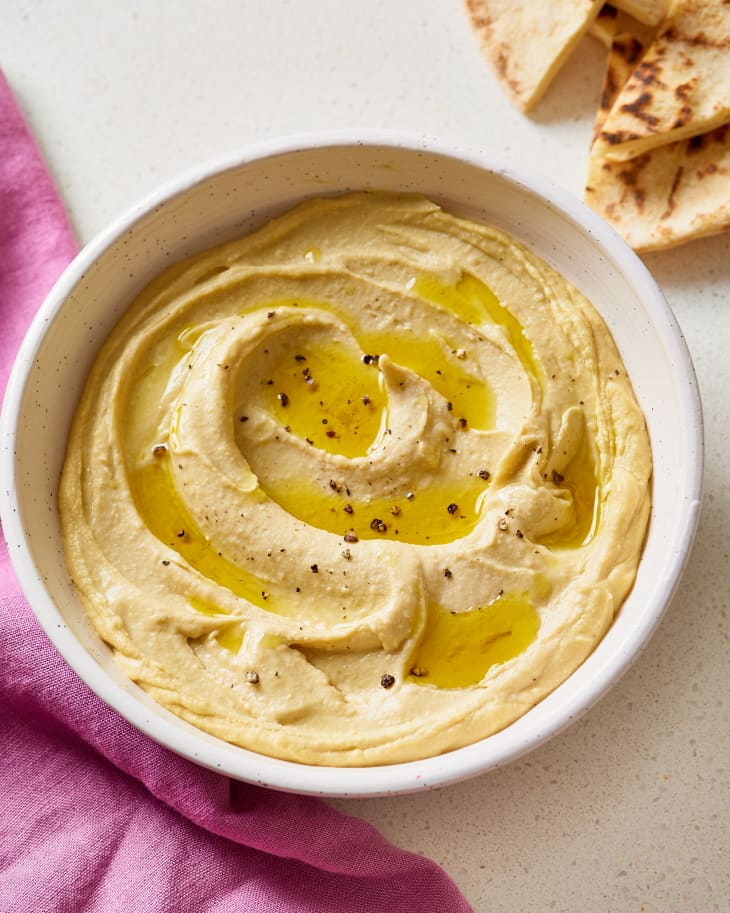 Hummus with olive oil and cracked pepper in a bowl