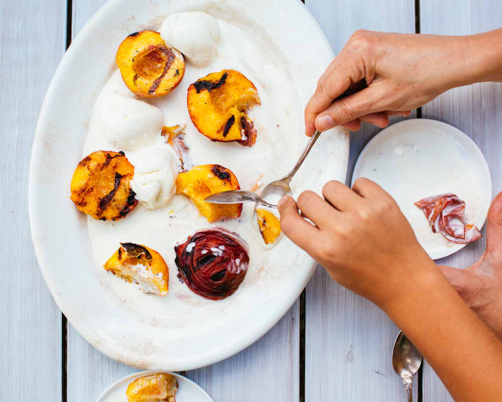 grilled peaches on plate with hands