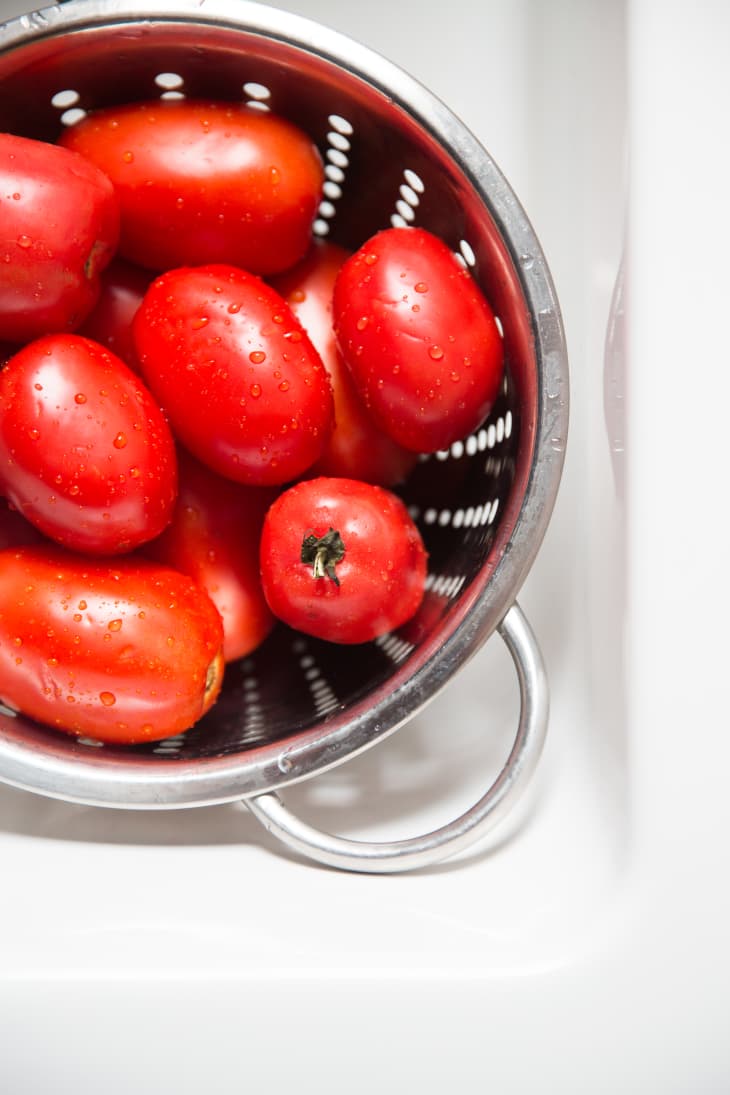 A colander with plum tomatoes